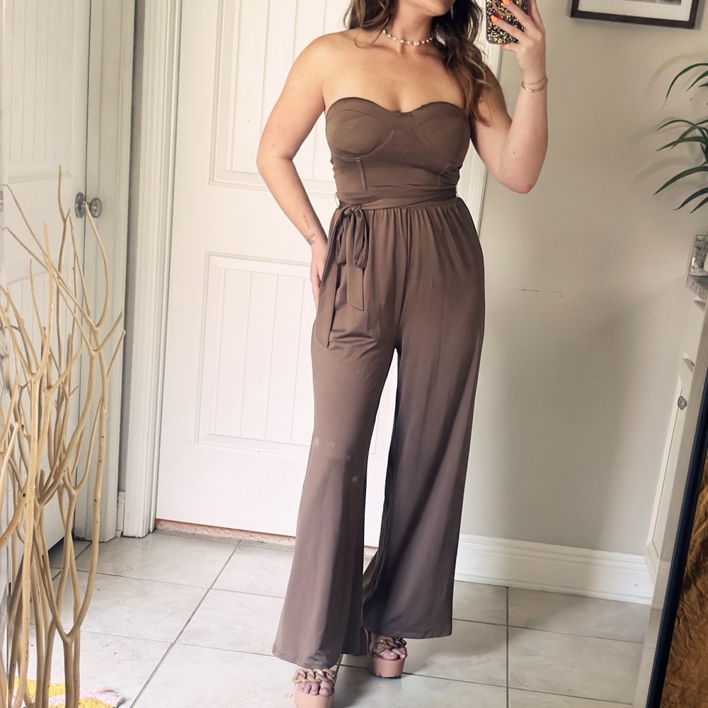 Never worn Romper with adjustable straps and built in padding.